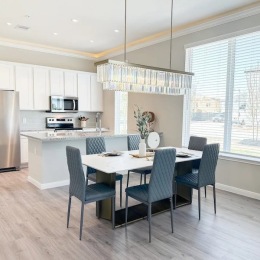 a kitchen with a dining table and chairs