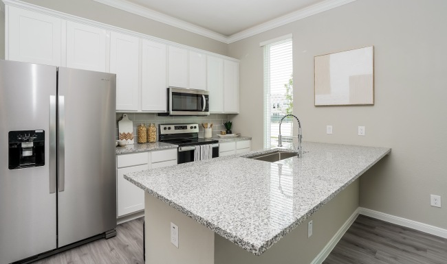 a kitchen with white cabinets