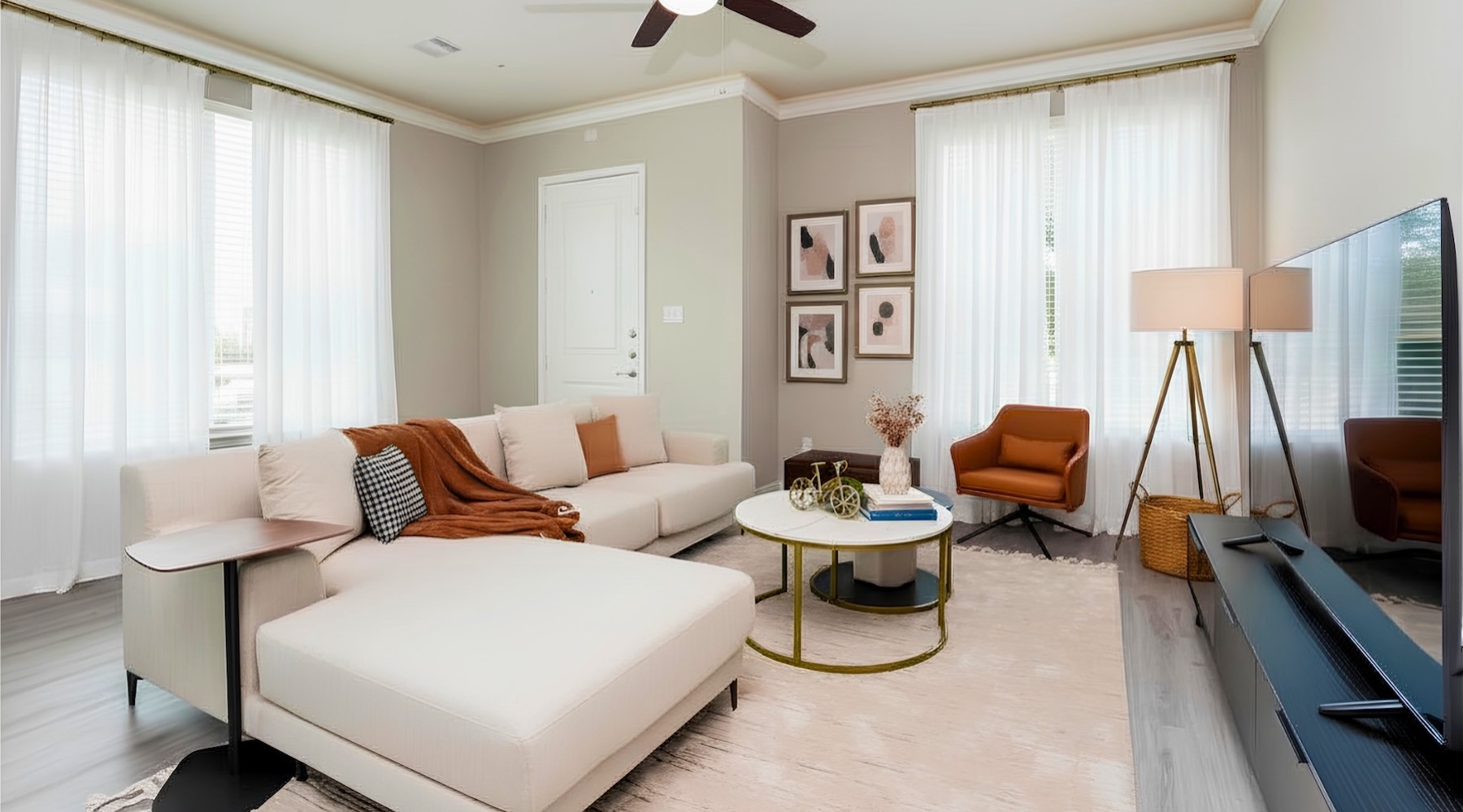 a living room with a couch, tv and a chair